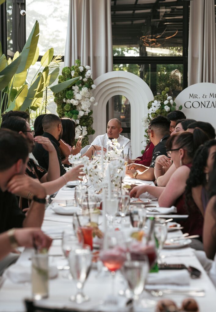 Wedding guests are captured enjoying a meal together at a Westcheser wedding reception 