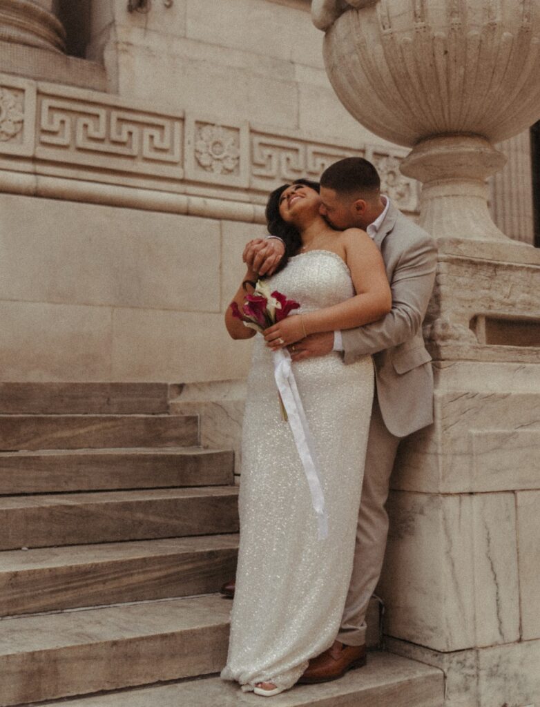 Newlyweds embrace in a photo taken by a NYC elopement photographer. 