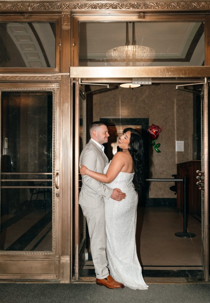 A couple poses for bridal portraits while waiting for their NYC city hall elopement ceremony. 