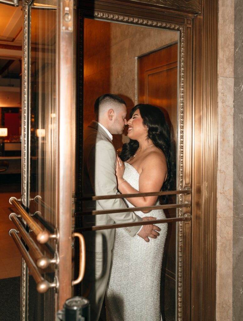 Newlyweds pose for a photo following their NYC City Hall elopement.