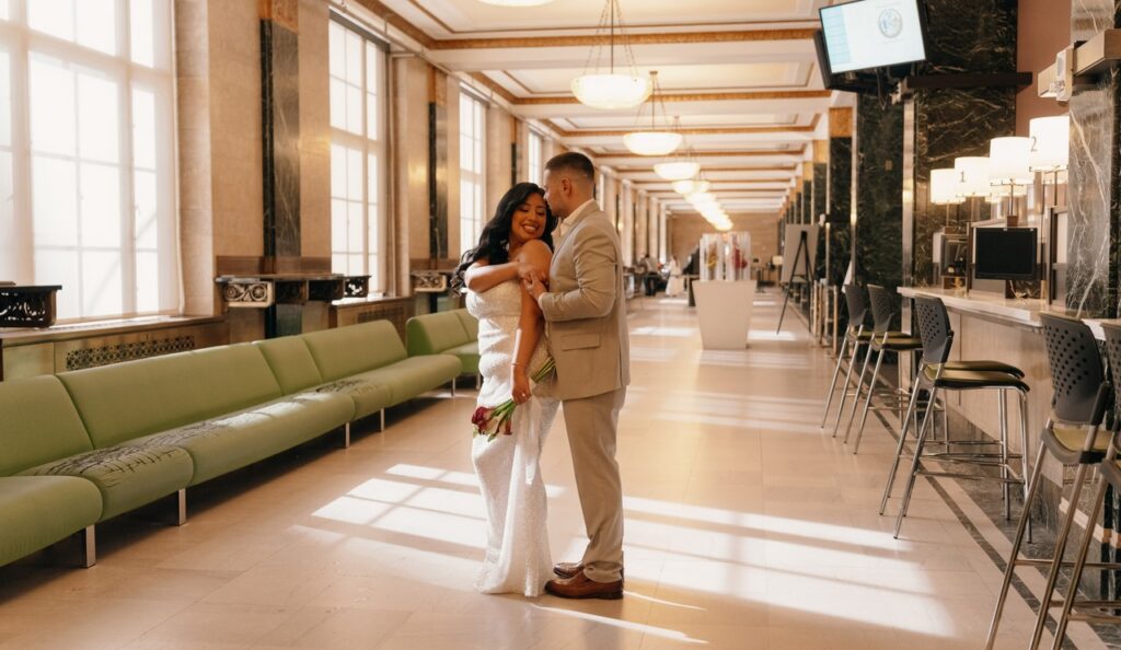 A NYC elopement photographer captures a newlywed couple in the waiting area of city hall before their elopement ceremony.
