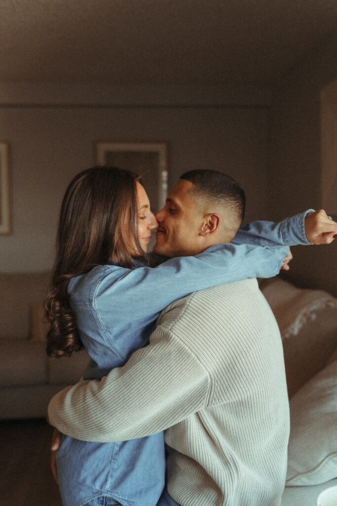 A couple share a kiss during engagement pictures NYC. 