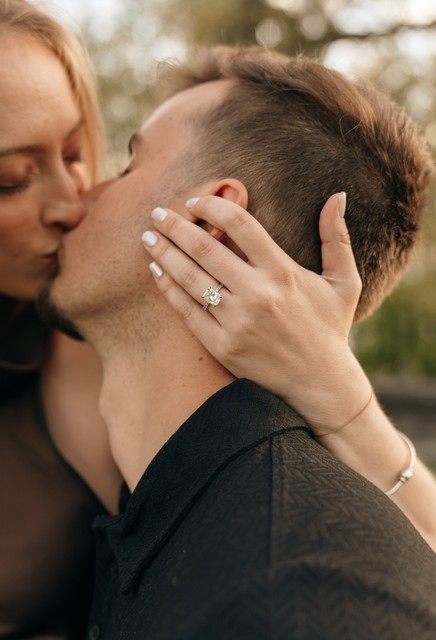 new york engagement photos show a close up of a diamond solitaire engagement ring during a shoot at rockwhood hall state park.
